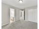 This bedroom features neutral paint, gray carpet, and a walk-in closet with a bathroom attached at 327 Oakland Bay Ct, Loganville, GA 30052