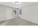 A bright bedroom with fresh paint and new carpet with two windows for natural light at 327 Oakland Bay Ct, Loganville, GA 30052