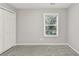 A bedroom with fresh paint, new carpet, a window and a closet at 327 Oakland Bay Ct, Loganville, GA 30052