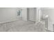Open bonus room with neutral carpet and a bright window at 327 Oakland Bay Ct, Loganville, GA 30052
