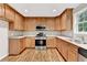 Open kitchen with modern stainless steel appliances and stylish cabinets at 327 Oakland Bay Ct, Loganville, GA 30052