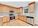 View of kitchen features with stainless steel appliances and light brown cabinets at 327 Oakland Bay Ct, Loganville, GA 30052