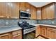 Close up of kitchen with stainless steel appliances and light brown cabinets at 327 Oakland Bay Ct, Loganville, GA 30052
