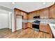 Kitchen boasts modern appliances and lots of storage space in the light brown cabinets at 327 Oakland Bay Ct, Loganville, GA 30052