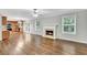 Spacious open-concept living area with fireplace, hardwood floors, and access to kitchen at 327 Oakland Bay Ct, Loganville, GA 30052