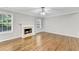 Bright living room featuring a fireplace, hardwood floors and views of the backyard at 327 Oakland Bay Ct, Loganville, GA 30052