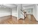 Spacious living room with hardwood floors, white trim, and a staircase at 327 Oakland Bay Ct, Loganville, GA 30052