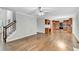 Bright living room with hardwood floors that opens to the kitchen with stainless steel appliances at 327 Oakland Bay Ct, Loganville, GA 30052