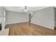 Large open living area features hardwood floors, a fireplace and neutral paint at 327 Oakland Bay Ct, Loganville, GA 30052
