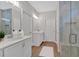 Modern bathroom featuring dual sinks, white cabinetry, and a glass-enclosed shower at 53 Colonial Ter, Villa Rica, GA 30180
