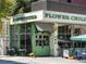 Flower restaurant with a colorful storefront offers a cheerful dining experience with outdoor seating at 1100 Howell Mill Nw Rd # 212, Atlanta, GA 30318