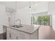 Bright kitchen view with island sink, stainless steel dishwasher, hardwood floors and a view to a large patio at 1100 Howell Mill Nw Rd # 212, Atlanta, GA 30318