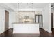 This kitchen features stainless steel appliances, a kitchen island, white cabinets, and tile backsplash at 1100 Howell Mill Nw Rd # 212, Atlanta, GA 30318