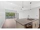 Bright living room with hardwood floors, recessed lighting, and a view to a large glass sliding door to a balcony at 1100 Howell Mill Nw Rd # 212, Atlanta, GA 30318