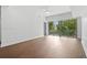 Bright living room featuring wood floors, a ceiling fan, and a large window for natural light at 1100 Howell Mill Nw Rd # 212, Atlanta, GA 30318