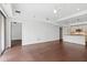 Sunlit living room with hardwood floors, large window, and open-concept kitchen at 1100 Howell Mill Nw Rd # 212, Atlanta, GA 30318