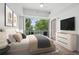 Inviting bedroom with plush bedding, a modern dresser, and a door to the balcony at 1100 Howell Mill Nw Rd # 212, Atlanta, GA 30318