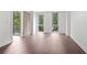 Bright bedroom with large windows, balcony access, and hardwood floors at 1100 Howell Mill Nw Rd # 212, Atlanta, GA 30318