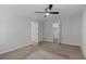 An empty bedroom with neutral carpet, a ceiling fan, two doors, and a window at 1150 Collier Nw Rd # 6H, Atlanta, GA 30318