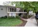 Apartment building exterior with upper-level balconies, landscaping, and sidewalk at 1150 Collier Nw Rd # 6H, Atlanta, GA 30318