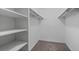 A walk-in closet features built-in shelving and ample storage space at 1150 Collier Nw Rd # 6H, Atlanta, GA 30318