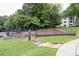 Fenced community dog park with seating, tables, and pet waste station at 1150 Collier Nw Rd # 6H, Atlanta, GA 30318