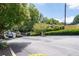 Gated entrance of Collier Green Condominiums surrounded by lush greenery at 1150 Collier Nw Rd # 6H, Atlanta, GA 30318