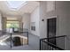 Well-lit hallway with stairway, modern railings, and exterior views at 1150 Collier Nw Rd # 6H, Atlanta, GA 30318