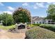 Sign for Collier Green Condominiums surrounded by a blooming Crape Myrtle tree at 1150 Collier Nw Rd # 6H, Atlanta, GA 30318