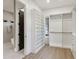 Walk-in closet with custom shelving, drawers, and access to the modern shower at 1820 Lake Dow Rd, Mcdonough, GA 30252
