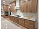 Modern kitchen features wooden cabinetry, quartz counters, and stainless appliances at 1820 Lake Dow Rd, Mcdonough, GA 30252