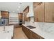 Well-lit kitchen featuring a marble backsplash, wood cabinets, and stainless steel appliances at 1820 Lake Dow Rd, Mcdonough, GA 30252