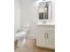 Stylish powder room with a floating vanity, modern fixtures, and white walls at 1820 Lake Dow Rd, Mcdonough, GA 30252