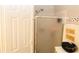 A partially frosted glass shower door with tiled walls and decorative towels at 5574 Mccrossin Cir, Lithonia, GA 30038