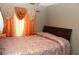Cozy bedroom with neutral walls and patterned bedspread at 5574 Mccrossin Cir, Lithonia, GA 30038