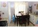Cozy breakfast nook features a wooden table, natural light, and tiled backsplash that complements the kitchen's design at 5574 Mccrossin Cir, Lithonia, GA 30038