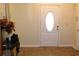 Inviting foyer features a classic oval window door and tiled flooring with space for decor, showcasing simple elegance at 5574 Mccrossin Cir, Lithonia, GA 30038