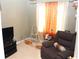 Casual living room with comfortable recliner and tile flooring at 5574 Mccrossin Cir, Lithonia, GA 30038