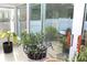 Sunroom filled with plants provides an outdoor view of a fence and landscaping at 5574 Mccrossin Cir, Lithonia, GA 30038