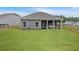 Well-manicured backyard with an enclosed patio and a classic wooden fence at 18 Torry Pines Cir, Villa Rica, GA 30180