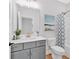 A well-lit bathroom featuring a shower-tub combo with a blue patterned shower curtain at 18 Torry Pines Cir, Villa Rica, GA 30180
