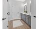 Bright bathroom featuring a double vanity, gray cabinetry, and modern fixtures at 18 Torry Pines Cir, Villa Rica, GA 30180