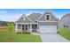 Beautiful single-Gathering home featuring a well-manicured lawn, gray siding, and a welcoming front porch at 18 Torry Pines Cir, Villa Rica, GA 30180