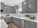 Modern kitchen with gray cabinetry, stainless steel appliances, and white marble countertops at 18 Torry Pines Cir, Villa Rica, GA 30180