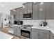 Modern kitchen with gray cabinets, stainless steel appliances, and white countertops at 18 Torry Pines Cir, Villa Rica, GA 30180
