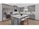 Contemporary kitchen with gray cabinets, stainless appliances, and a white countertop island with seating at 18 Torry Pines Cir, Villa Rica, GA 30180