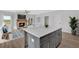 Open-concept living room featuring a stone fireplace and a kitchen island with white countertop at 18 Torry Pines Cir, Villa Rica, GA 30180