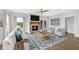 Living room featuring a stone fireplace, light-filled windows, and modern decor at 18 Torry Pines Cir, Villa Rica, GA 30180
