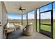 Bright sunroom with stylish seating and beautiful outdoor view at 18 Torry Pines Cir, Villa Rica, GA 30180