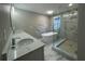 Modern bathroom featuring a walk-in shower, a freestanding soaking tub, and a double vanity at 3189 A Jackson, Hapeville, GA 30354